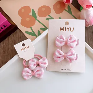 Set di fermagli e elastici per capelli con fiocchi rosa a pois in stile elegante