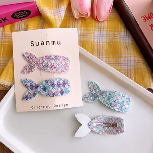 Detail of glitter mermaid tail hair clips for girls showing sequins and metal back clips