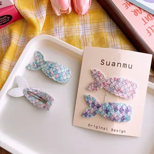 Close-up of glitter mermaid tail hair clips for girls on decorative display card