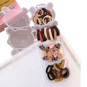 Cute bear-shaped multi-compartment storage box filled with colorful elastic hair ties and clips