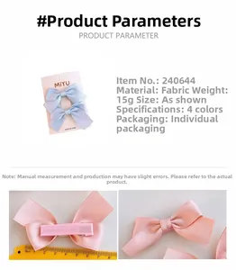 Close-up of pink and blue fabric bow hair clips with size measurement on a card