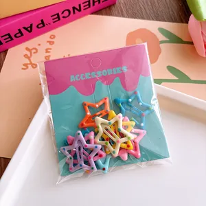 Close-up of star-shaped hair clips with colorful polka dots on professional card packaging