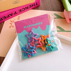 Star-shaped colorful hair clips set on card display with vibrant matte finishes