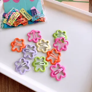 Close-up of matte macaron color metal BB hair clips in wave and teardrop shapes