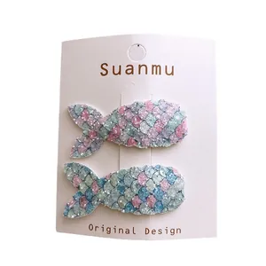Glittery mermaid tail hair clips for girls in colorful sequins on a display card