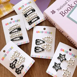 Polka dot hair clip set featuring stars and hearts on a decorative display card