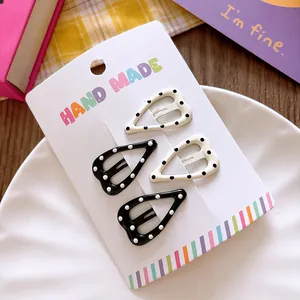 Polka dot star hair clips set in black and white on decorative handmade display card