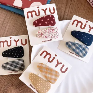 Detail of fabric wrapped BB clips with floral, polka dot and plaid patterns for girls