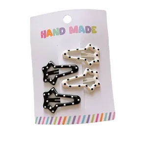 Star-shaped polka dot hair clips in black and white set for women and girls