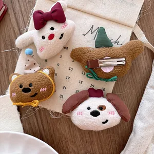 Detail showing the plush fabric texture and embroidered animal faces on cartoon hair clips