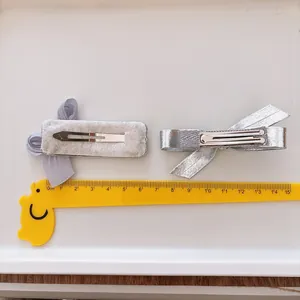 Silver ribbon bow hair clips with purple felt accent and measurement ruler scale
