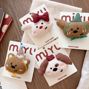 Detail shot of four cute plush animal hair clips with soft fabric and stitched facial features