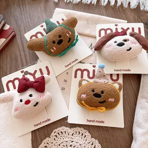 Close-up of four plush cartoon animal hair clips featuring teddy bears and rabbits