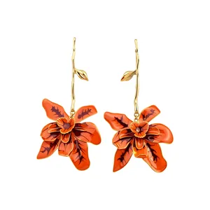 Elegant exaggerated long orchid flower earrings with orange enamel and gold finish