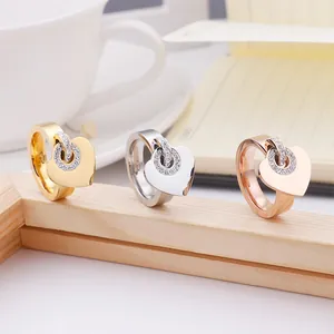 Three stainless steel heart rings with sparkling crystals in gold and silver finishes