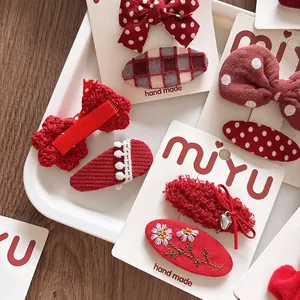 Sweet red fabric bow hair clips set for girls featuring embroidery and plaid patterns
