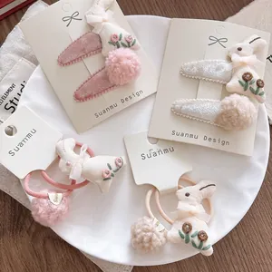 Detailed embroidery and soft plush ball texture on pink rabbit hair accessories