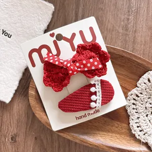 Detail of handmade red crochet bow hair clip and lace BB clip set for girls