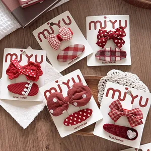 Red ribbon bow and fabric clip set for girls with classic patterns and sweet lace details
