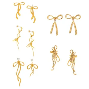 Elegant 18K gold plated bow ribbon tassel earrings set with crystal details on white background