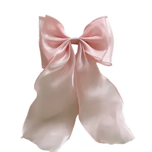 Pink oversized bow hair clip with long ribbons in lightweight organza material