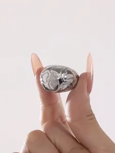 Close-up of heart-shaped embossed texture on silver-tone cast stainless steel ring