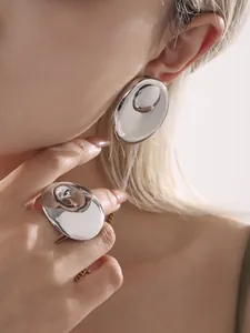 Polished silver geometric liquid metal earring and ring set on model view