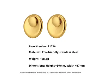 Close-up of golden stainless steel double disc earrings with matte finish details