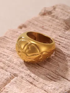Detailed view of the 18k gold plated stainless steel heart texture ring on natural rock