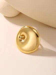Macro view of a gold concave disc ring with a polished metallic mirror finish