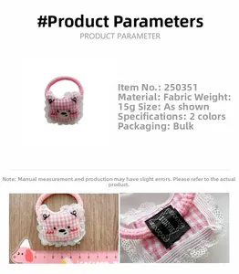 Close-up of cute pink plaid bear hair tie with lace trim and embroidered details