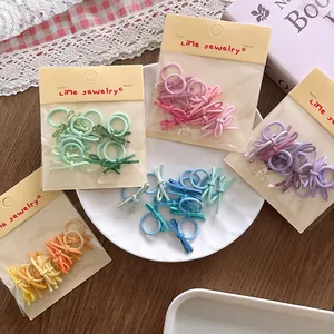 Close-up of candy-colored mini bow hair ties in various macaron shades for toddlers