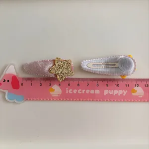 Pink velvet hair clips for girls featuring gold glitter stars in a pair set