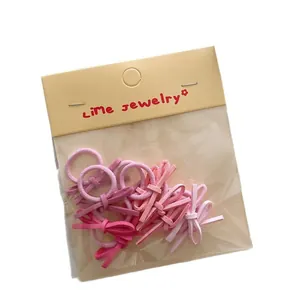 Pink candy-colored mini bow hair ties set with lime jewelry packaging for kids
