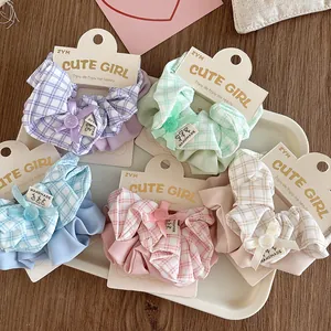 Set of 5 plaid scrunchies in pastel colors with handmade bow details and display card