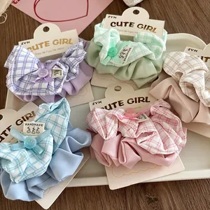 Set of 5 pastel plaid scrunchies with cute bows and buttons on a display card