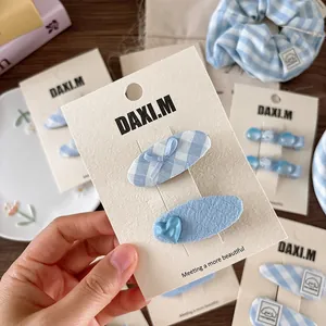 Blue plaid bow and heart hair clip set on display card for girl casual hairstyling
