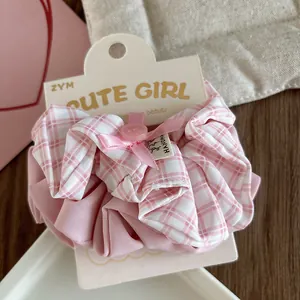 Detail of pink plaid scrunchie set with handmade label and cute button decor