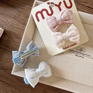 Sweet 4-piece set of floral and plaid fabric bow hair clips for girls on display card