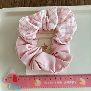 Pink solid and plaid pattern fabric scrunchie set for women shown with measuring ruler
