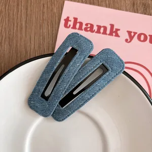 Gros plan de barrettes rectangulaires en denim bleu sur une petite assiette blanche