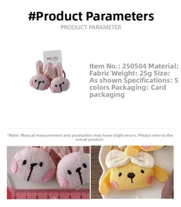 Detailed view of plush rabbit and duck hair ties showing fabric texture and size measurement