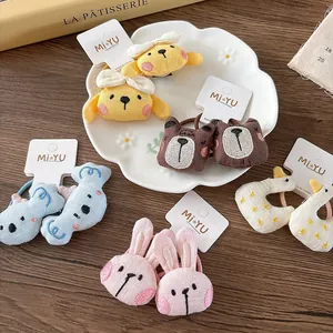 Cute 3D plush animal hair ties with cartoon bunny and bear embroidery on display