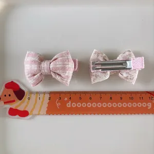 Pair of sweet floral and plaid fabric bow hair clips for girls with metal duckbill clips