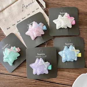 Détail de cinq barrettes à cheveux étoiles pailletées pour filles aux couleurs pastel assorties