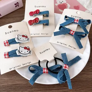 Detail of denim bow hair clips and Hello Kitty resin accessories on a display card