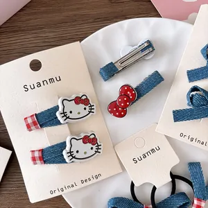 Detailed set of blue denim and red bow hair clips with cute kitty motifs on display