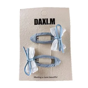 Blue plaid fabric hair clips set with lace bow design on beige card, stylish for girls