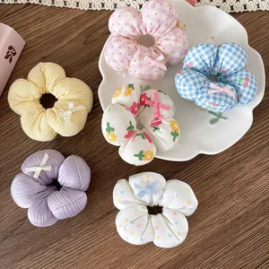 Set di 6 elastici per capelli a fiori in tessuto con fiocchi su fondo in legno