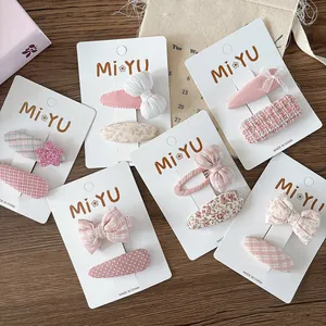Pink and beige fabric bow hair clip set with floral and polka dot patterns for girls